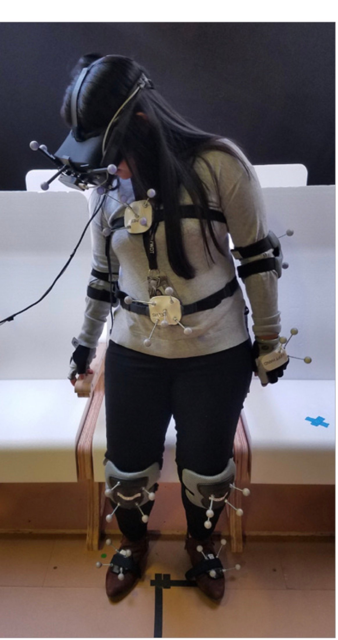 Researcher wearing a full motion-capture suit and VR headset